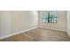Bright bedroom with wood floors and large windows with blinds, offering ample natural light at 429 Alberata Way, Nokomis, FL 34275