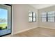 Bright bedroom with wood floors, views of the backyard, and a sliding door to the outside at 429 Alberata Way, Nokomis, FL 34275