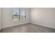 Sunlit bedroom with wood-look flooring and double windows at 429 Alberata Way, Nokomis, FL 34275