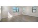 Bright bedroom features wood-look tile flooring and large windows with horizontal blinds at 429 Alberata Way, Nokomis, FL 34275