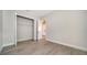 Bedroom with wood-look flooring and an open closet at 429 Alberata Way, Nokomis, FL 34275