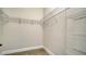 Walk-in closet with laminate floors, wire shelving, and white baseboards at 429 Alberata Way, Nokomis, FL 34275