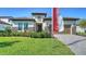 Beautiful home exterior with a well-maintained lawn and attractive stone accents at 429 Alberata Way, Nokomis, FL 34275