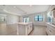 Spacious kitchen with island, stainless steel dishwasher, and modern fixtures open to the living area at 429 Alberata Way, Nokomis, FL 34275