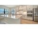 Stylish kitchen with island, stainless steel appliances, white cabinets, and backyard views at 429 Alberata Way, Nokomis, FL 34275