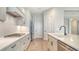 Modern kitchen featuring stainless steel appliances, subway tile backsplash, and sleek white cabinetry at 429 Alberata Way, Nokomis, FL 34275