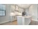 Elegant kitchen with white cabinetry, stainless steel appliances, and quartz countertops at 429 Alberata Way, Nokomis, FL 34275