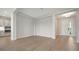 Open living space with light wood floors, neutral walls, and a view of the outdoors at 429 Alberata Way, Nokomis, FL 34275