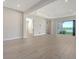 Bright living space with open floor plan, neutral walls, and sliding glass doors to a view at 429 Alberata Way, Nokomis, FL 34275