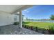 Covered patio with stunning lake views and well-maintained landscaping at 429 Alberata Way, Nokomis, FL 34275