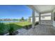 Covered patio with pavers and a tranquil lake view at 429 Alberata Way, Nokomis, FL 34275