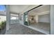 Spacious covered patio offering seamless indoor-outdoor living with a view of a modern kitchen at 429 Alberata Way, Nokomis, FL 34275