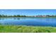 Scenic pond view with lush green surroundings and houses in the background creating a peaceful community setting at 429 Alberata Way, Nokomis, FL 34275