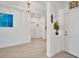 Bright foyer with tile floors, a decorative surfboard, and white walls at 5415 Limelight Dr, Apollo Beach, FL 33572