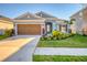 Charming single-story home featuring a manicured front yard and a two-car garage at 5415 Limelight Dr, Apollo Beach, FL 33572