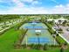 Aerial view of well-maintained community tennis courts with covered seating at 5415 Limelight Dr, Apollo Beach, FL 33572