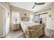 Main bedroom with a queen-size bed, ceiling fan, and an ensuite bathroom at 5201 Highbury Cir, Sarasota, FL 34238