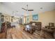 Spacious living room with hardwood floors and a large TV at 5201 Highbury Cir, Sarasota, FL 34238