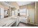 Main bathroom with a double vanity and a large tub at 5201 Highbury Cir, Sarasota, FL 34238