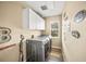 Laundry room with washer, dryer, cabinets, and decorative accents at 5201 Highbury Cir, Sarasota, FL 34238