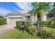 Front view of house; attached garage, manicured lawn, and walkway at 5201 Highbury Cir, Sarasota, FL 34238