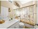 Clean bathroom with a shower/tub combo and palm-themed decor at 5201 Highbury Cir, Sarasota, FL 34238