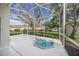 Hot tub on a screened patio overlooking the backyard at 5201 Highbury Cir, Sarasota, FL 34238