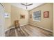 Cozy bedroom with hardwood floors and a wicker chair at 5201 Highbury Cir, Sarasota, FL 34238