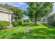 Landscaped backyard with irrigation system, overlooking a lake at 5201 Highbury Cir, Sarasota, FL 34238