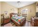 Bedroom with wooden furniture and a decorative headboard at 5201 Highbury Cir, Sarasota, FL 34238