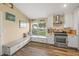 Updated kitchen with white cabinets, stainless steel appliances and built-in bench at 5201 Highbury Cir, Sarasota, FL 34238