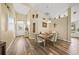 Casual dining area with wood flooring and a view into the kitchen at 5201 Highbury Cir, Sarasota, FL 34238