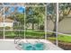 Relax in this screened-in hot tub, overlooking a tranquil backyard at 5201 Highbury Cir, Sarasota, FL 34238