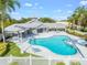 Community pool, clubhouse, and surrounding landscape at 5201 Highbury Cir, Sarasota, FL 34238