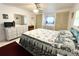 Spacious bedroom with a queen-size bed, dresser, and mirror at 3311 Overcup Oak Ter, Sarasota, FL 34237