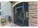 Inviting exterior entrance with a screened door and stone accents at 5922 Wake Forest Run # 101, Bradenton, FL 34211