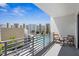 Balcony overlooking a community pool with outdoor seating and views of nearby buildings at 1703 N Tamiami Trl # 302, Sarasota, FL 34234