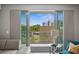 Living room view of the balcony and a partial view of the condo community at 1703 N Tamiami Trl # 302, Sarasota, FL 34234