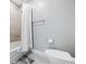 Cozy bathroom featuring a full bathtub with shower, tiled surround, and modern toilet and fixtures at 1703 N Tamiami Trl # 302, Sarasota, FL 34234