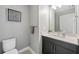 Bathroom featuring a toilet and vanity with a sink and mirror at 1703 N Tamiami Trl # 302, Sarasota, FL 34234