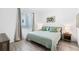 Bedroom with large bed, side tables and lamps at 1703 N Tamiami Trl # 302, Sarasota, FL 34234