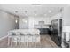 Bright kitchen featuring a large island with seating, modern lighting, and stainless steel appliances at 1703 N Tamiami Trl # 302, Sarasota, FL 34234