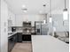 Modern kitchen with stainless steel appliances, white cabinets, and a spacious quartz countertop island at 1703 N Tamiami Trl # 302, Sarasota, FL 34234