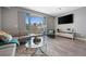 Comfortable living room featuring modern furniture and an exterior view at 1703 N Tamiami Trl # 302, Sarasota, FL 34234