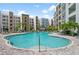 Community pool offering ample space for relaxation and recreation in a beautiful outdoor setting at 1703 N Tamiami Trl # 302, Sarasota, FL 34234