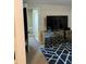 Living room featuring a television on a mirrored console and a hallway leading to other rooms at 3375 8Th St, Sarasota, FL 34237