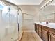 Bathroom with glass door shower with tropical motif and vanity sink at 4145 Reflections Pkwy, Sarasota, FL 34233
