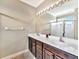 Bathroom features a dual vanity, large mirror and glass-enclosed shower at 4145 Reflections Pkwy, Sarasota, FL 34233