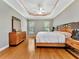 Large bedroom with wood floors, dresser and window views at 4145 Reflections Pkwy, Sarasota, FL 34233