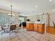Open dining area adjacent to the kitchen with tile floors and view into the living area at 4145 Reflections Pkwy, Sarasota, FL 34233